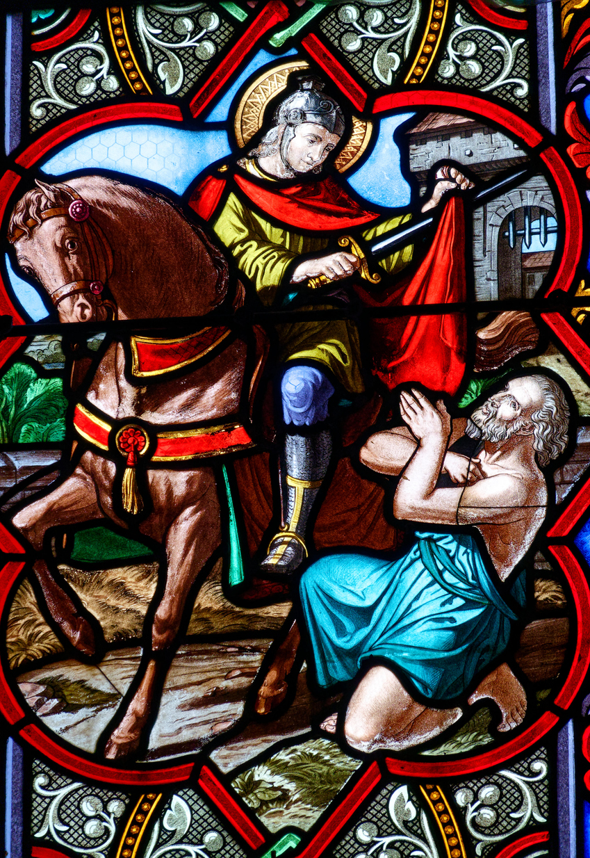 Église Saint Martin - Mardié, FRANCE - 01-26-2025: Stained glass (19th century) of Saint Martin of Tours cuting a piece of his cloak for a beggar. Saint of the Roman Catholic Church.